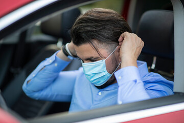 Handsome young man putting on corona virus mask