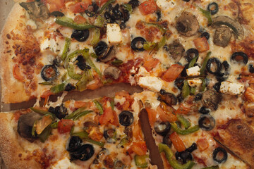 pizza with mushrooms, olive and other various products, close up