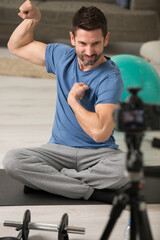 vlogger flexing his muscles while filming exercise video