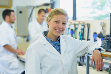 female worker in lab coats looking at camera