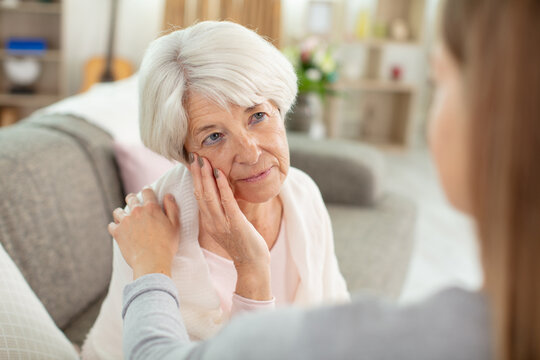 Girl Comforting Distressed Elderly Woman