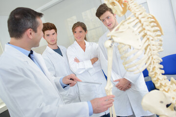 Teacher and students looking at skeleton