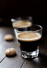 Two Glasses Of Coffee on dark wooden background. Close up.	