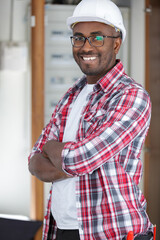 smiling man standing with his arms crossed