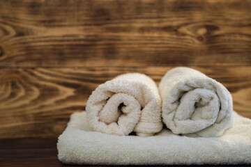 Obraz na płótnie Canvas natural cotton towels for Spa treatments and massages on a wooden background. towel after shower and bath
