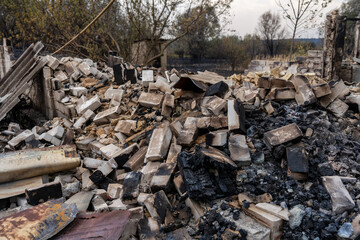 Pile of burnt bricks from a destroyed house after the fire