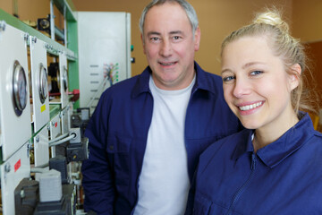 Fototapeta premium female future technician posing next to panel with gauges