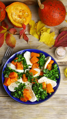 Autumn salad with pumpkin on a plate. Autumn food. Fall mood.