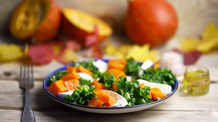 Autumn salad with pumpkin on a plate. Autumn food. Fall mood.