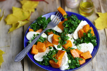 Autumn salad with pumpkin on a plate. Autumn food. Fall mood.