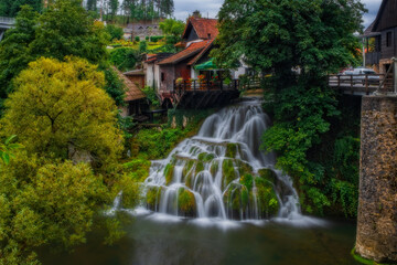 Fototapeta na wymiar Prvi Slap - First Waterfall on Korana river canyon in village of Rastoke. Slunj in Croatia. Near Plitvice Lakes National Park. August 2020, long exposure picture.