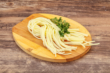 Chechil spaghetti cheese over board