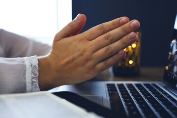 Woman praying by faith with computer laptop, Church services online concept, Online church at home...