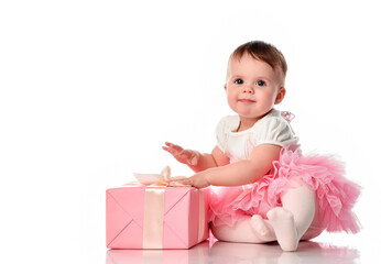 Girl sitting on the floor with a gift box and smiling.