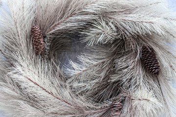 Natural wheat-colored branches with pine cone wreath - very close-up - Thanksgiving or Christmas background