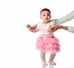 Mother teaching cute toddler daughter to walk
