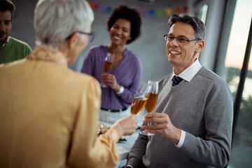 Happy businessman toasting with colleague on office party.