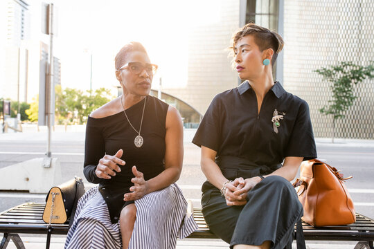 Stylish Mature Women Friends Talking On City Bench