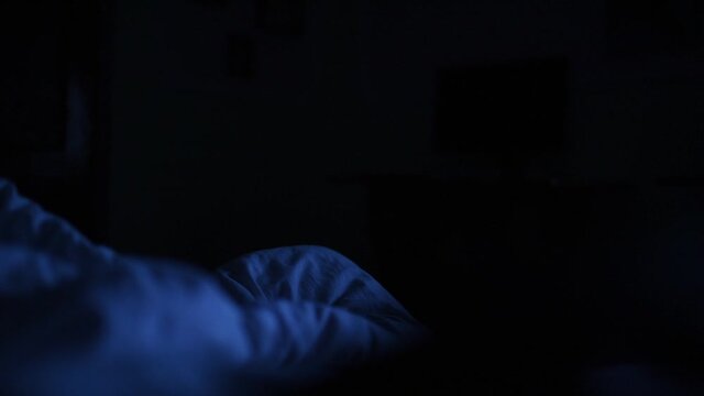 White blanket close up in the dark night in the blue light.