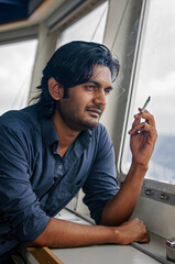 Man smoking cigarette at the window