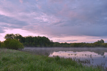 Obraz premium colorful and misty dawn over a small river