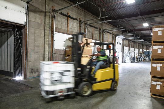 Forklift Driver Moving Stock To Loading Bay