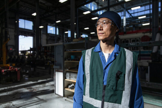 Portrait thoughtful male transit worker in maintenance facility