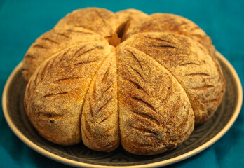 Homemade pastry, fresh pumpkin-shaped bread, background for Thanksgiving and Halloween.