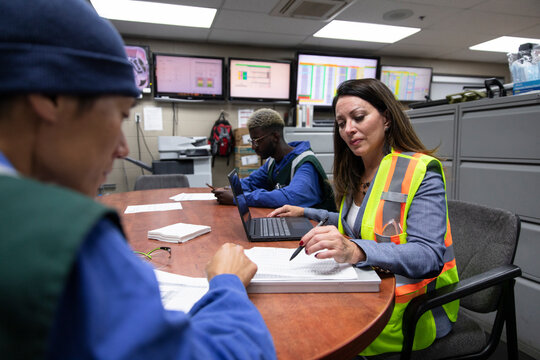 Transit manager and workers in maintenance facility office