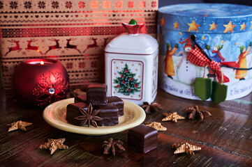 Atmospheric scene of a Christmas decorated wooden table with sweet gingerbread pastry.