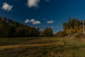 Obraz na płótnie Canvas Big color meadows and path with blue sky and white clouds near Utery town