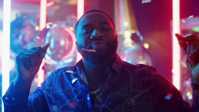 African american man making movements at party. Afro guy dancing in club