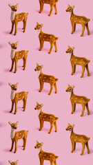 Christmas layout pattern made with reindeer toy on the bright pink background. Minimal New Year or winter season concept. Greeting card or banner.