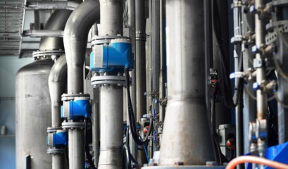 Large industrial water treatment and boiler room. Piping, servo butterly vlaves, flanges, pressure vessels