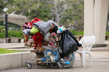 Life on the street, homeless man lives out of a shopping cart, poverty - obrazy, fototapety, plakaty