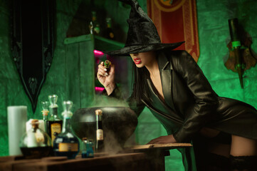 Fototapeta na wymiar women in a hat in the witch's room on Halloween
