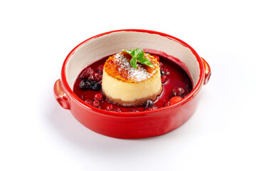 Italian panna cotta dessert with strawberries and wild berries in a bowl isolated on white
