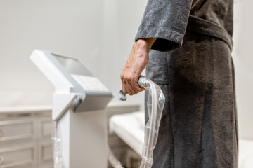Man measuring body composition balance, holding handles of a medical scales during Inbody test