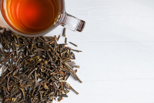 Sagan Daila tea leaves and a cup of tea on a white background with space for text. Rhododendron of Adamsia.