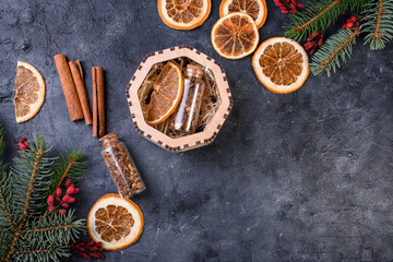Obraz na płótnie Canvas New Year's set for mulled wine in a wood box. Fragrant spices, orange peel, cinnamon sticks, badyan.