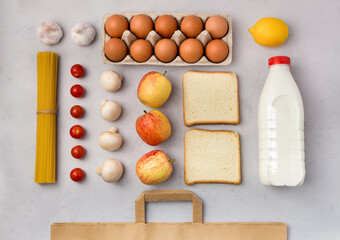 Set of grocery items flat lay on gray background. Online order of nutrition. Food delivery at home. Contactless internet order of goods from the store. Takeaway products.