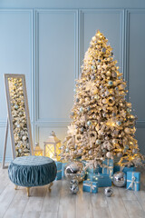 Stylish Christmas interior decorated in blue colors. Comfort home. Sofa, gifx boxes, mirror balls, garland, candle lamp.