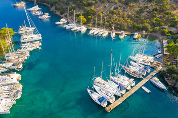 aerial view to boats in marine of yacht club with emerald water 