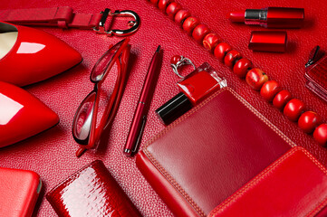 Woman red accessories, jewelry, cosmetic, shoes and other luxury objects on leather background, fashion industry, modern female concept, selective focus