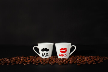 Espresso coffee cups with coffee beans on black background. Romantic mood card, valentines day.