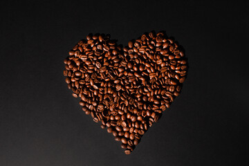 brown coffee beans heart shaped, background texture, close-up