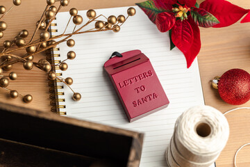 An ornament red mail box saying Letter to Santa on a notebook. Christmas tree decoration ideas.  - 388864363