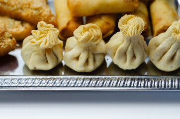 Sweet and sour vegetable wontons, Traditional chinese dumplings filled with bean sprouts, red bell peppers, carrot, cabbage and spring onions