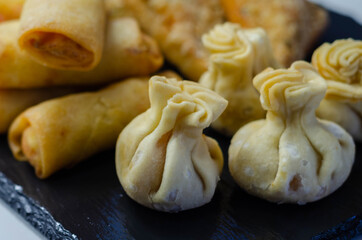 Sweet and sour vegetable wontons, Traditional chinese dumplings filled with bean sprouts, red bell peppers, carrot, cabbage and spring onions