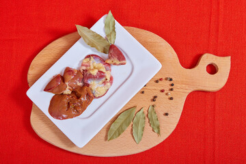 Chicken offal on a red background.